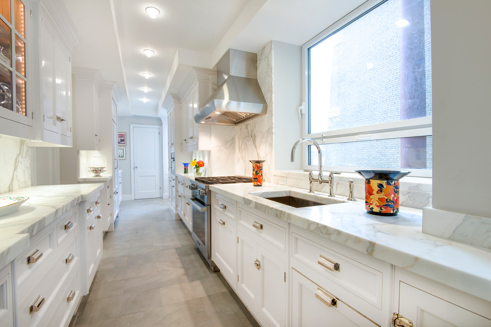 Transitional galley kitchen in New York with an undermount sink, recessed-panel cabinets, white cabinets, stainless steel appliances and no island.