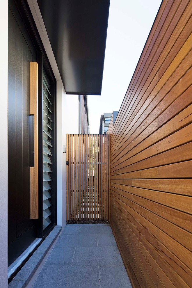 Inspiration for a modern entryway in Sydney with a single front door and a black front door.