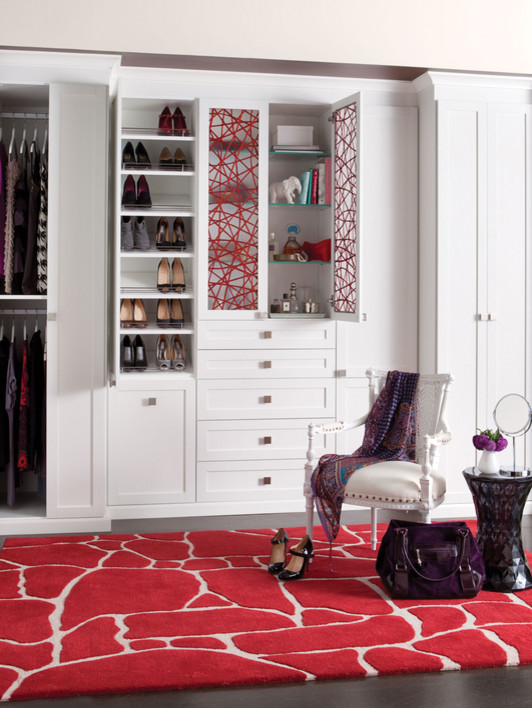 This is an example of a large eclectic women's built-in wardrobe in Seattle with recessed-panel cabinets, white cabinets and dark hardwood floors.