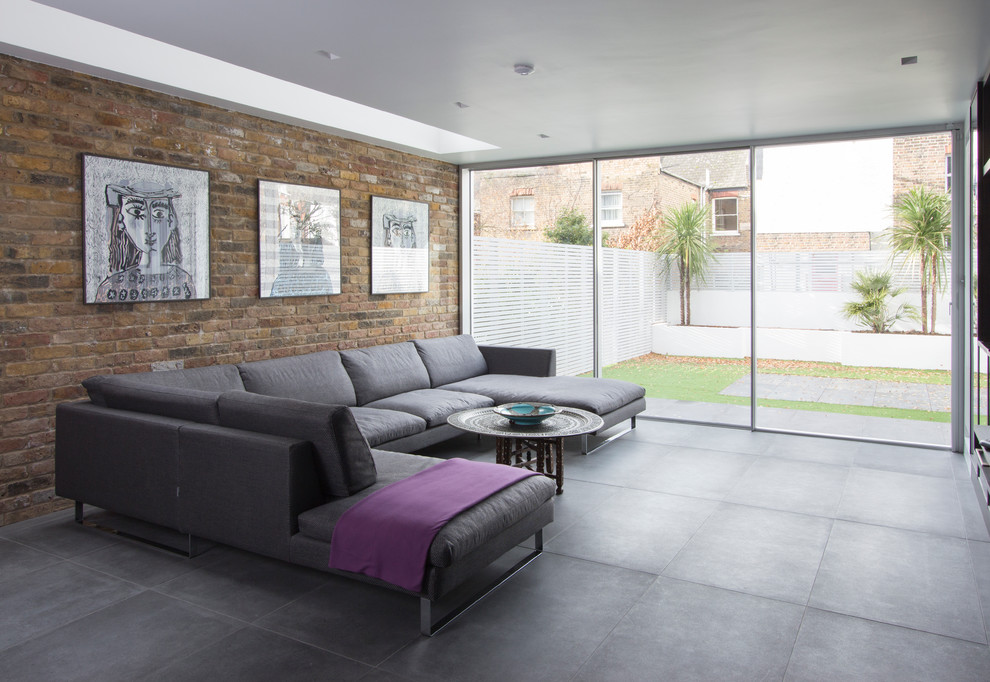 This is an example of a contemporary living room in London with concrete floors.