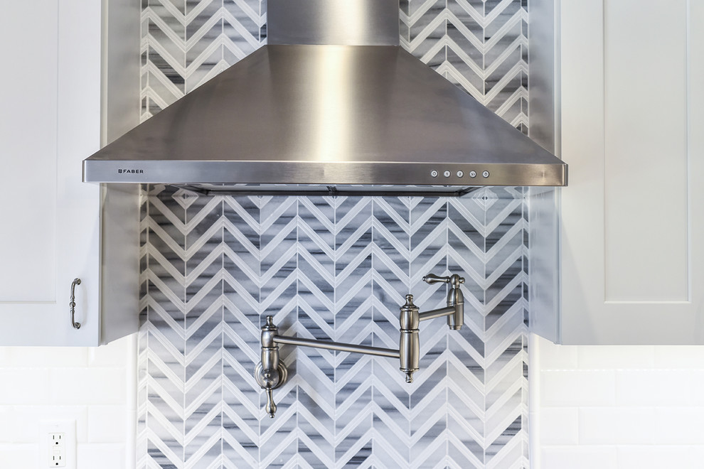 Inspiration for a large transitional l-shaped medium tone wood floor home design remodel in Jacksonville with a farmhouse sink, shaker cabinets, quartz countertops and an island