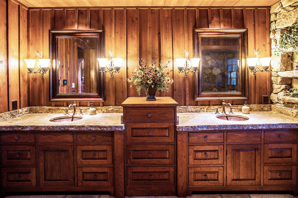 Photo of a mid-sized country master bathroom in Other with an undermount sink, recessed-panel cabinets, medium wood cabinets, granite benchtops, an alcove tub, a corner shower, brown walls and travertine floors.