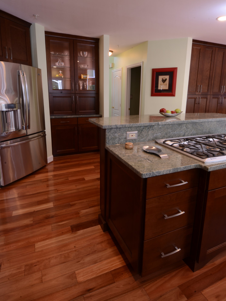 Inspiration for a mid-sized transitional l-shaped dark wood floor and brown floor eat-in kitchen remodel in Baltimore with shaker cabinets, dark wood cabinets, granite countertops, stainless steel appliances and an island