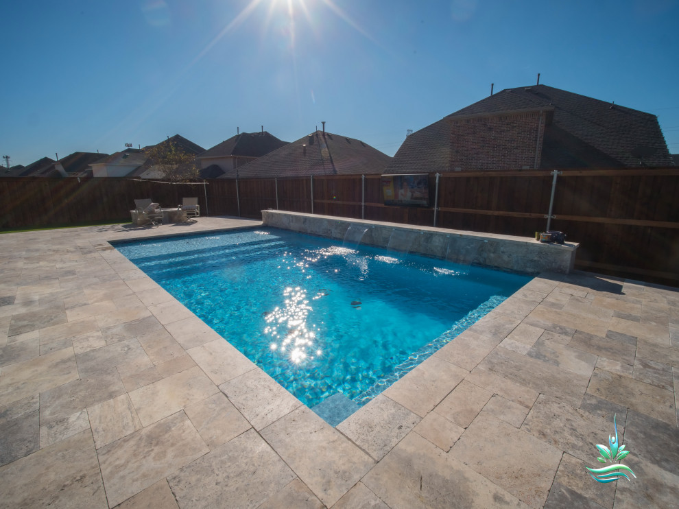Design ideas for a mid-sized modern side yard rectangular lap pool in Dallas with with a pool and natural stone pavers.