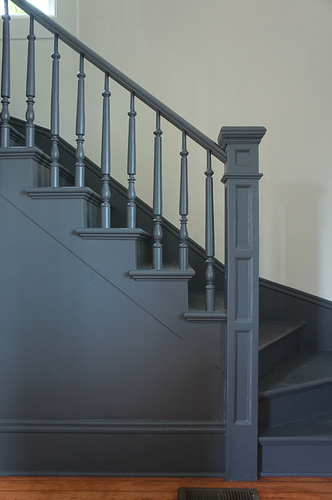 Mid-sized traditional painted wood l-shaped staircase in Portland with painted wood risers and wood railing.