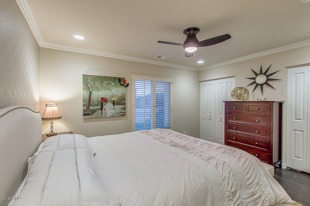 Contemporary master bedroom in Phoenix with beige walls.