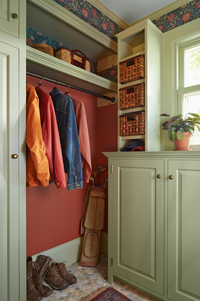 Inspiration for a traditional mudroom in Minneapolis with red walls and slate floors.