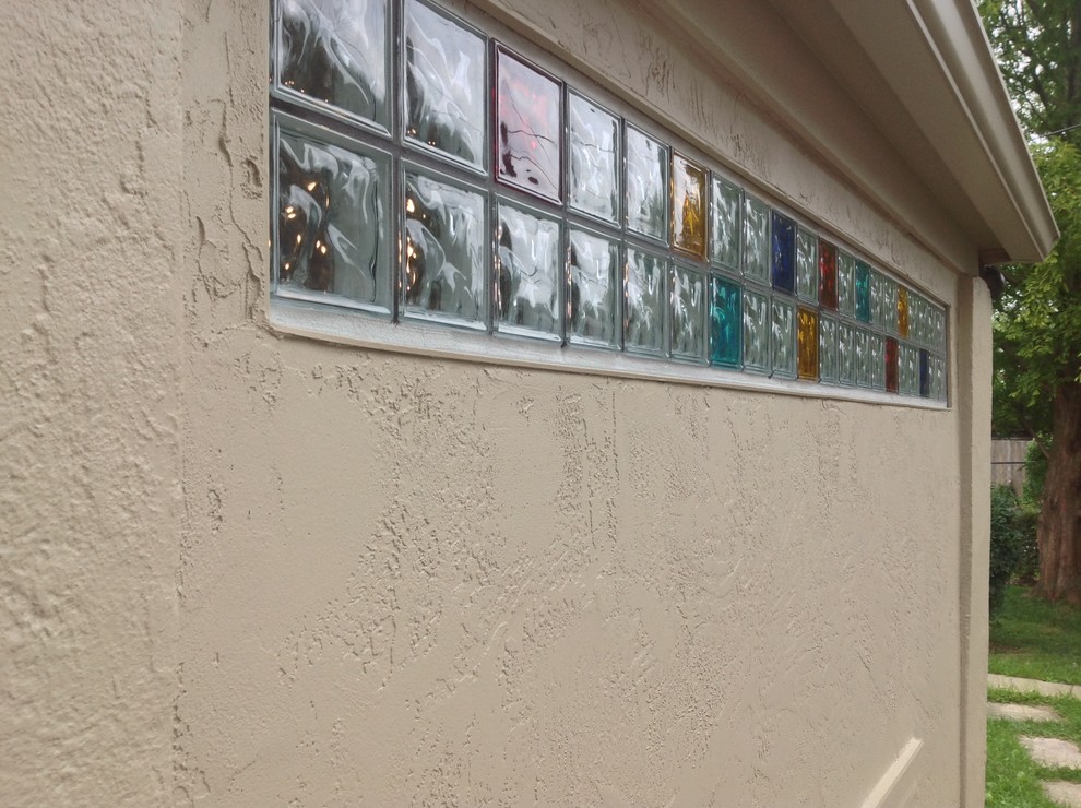 Exterior view of colored glass block transom in a stucco wall