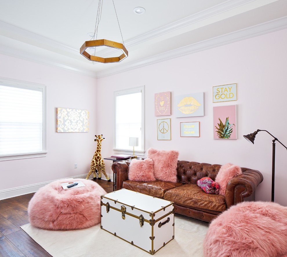 Large transitional loft-style living room in Orlando with pink walls, brown floor and medium hardwood floors.