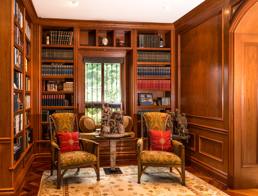Inspiration for a mid-sized traditional study room in DC Metro with brown walls, dark hardwood floors and a built-in desk.