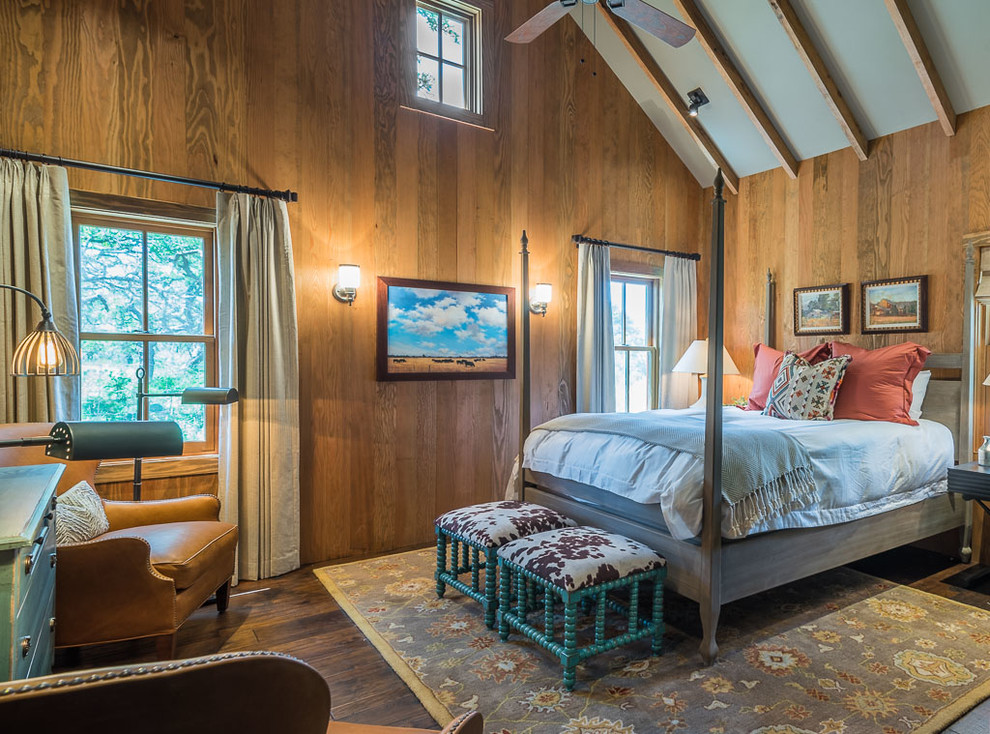 Photo of a country bedroom in Austin with dark hardwood floors.