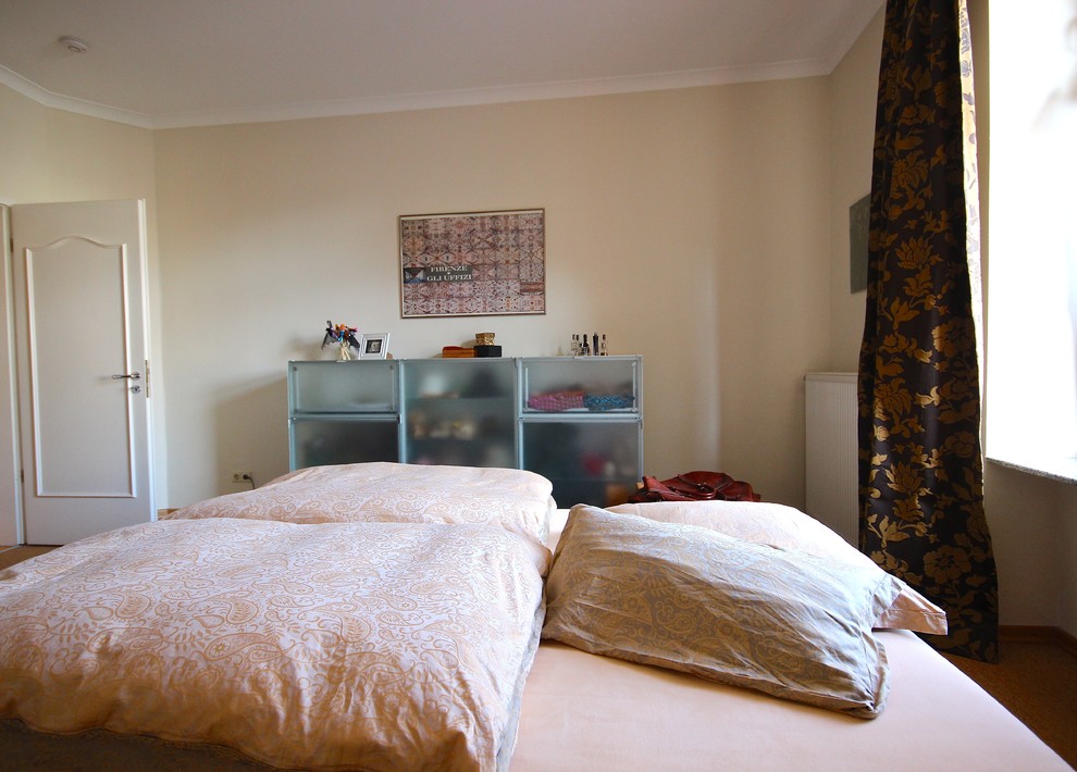 Large eclectic master bedroom in Frankfurt with beige walls, dark hardwood floors and brown floor.
