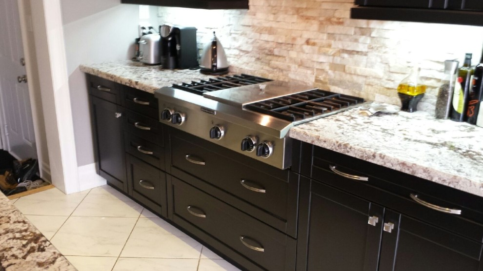 Photo of a mid-sized traditional galley separate kitchen in Toronto with a double-bowl sink, recessed-panel cabinets, dark wood cabinets, marble benchtops, beige splashback, slate splashback, stainless steel appliances, ceramic floors, with island, beige floor and multi-coloured benchtop.