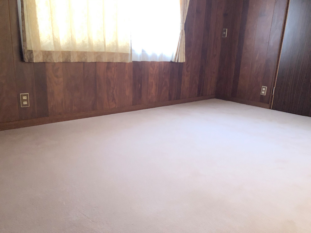 Medium sized traditional master bedroom in Other with brown walls, carpet and beige floors.