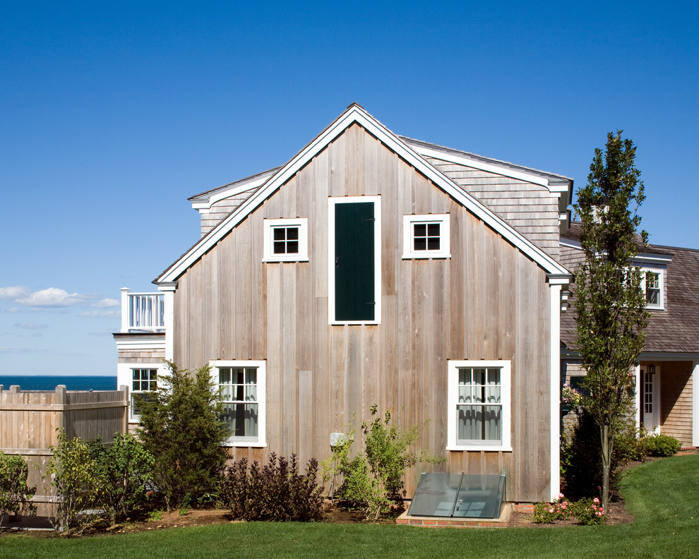 This is an example of a mid-sized beach style two-storey exterior in Boston with wood siding.