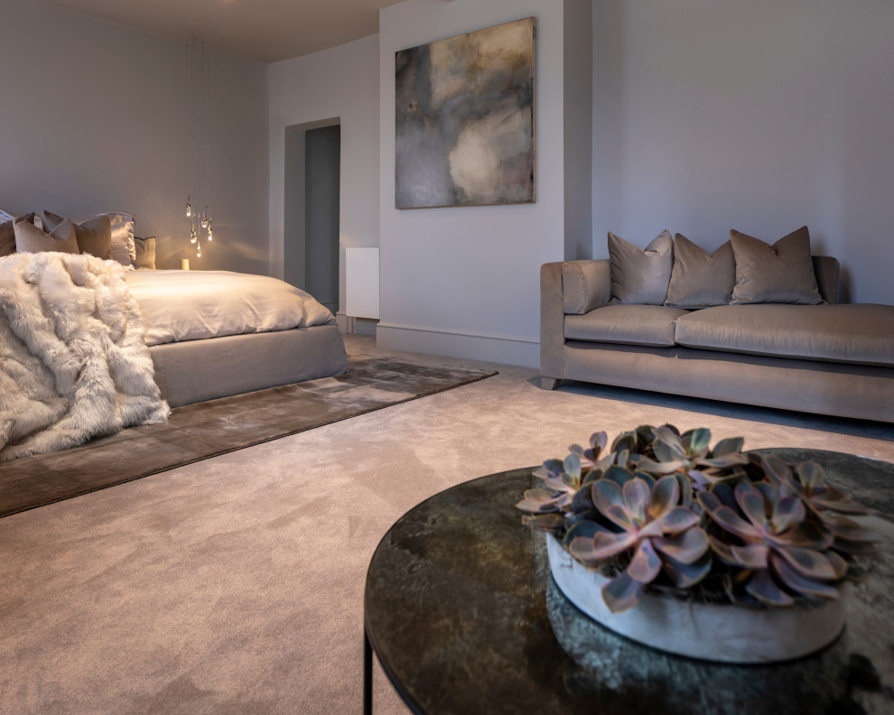 Large contemporary master bedroom in West Midlands with grey walls, carpet and grey floor.