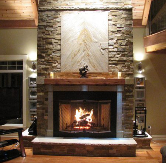 Asian inspired stacked stone fireplace with wood mantel and exposed beams.