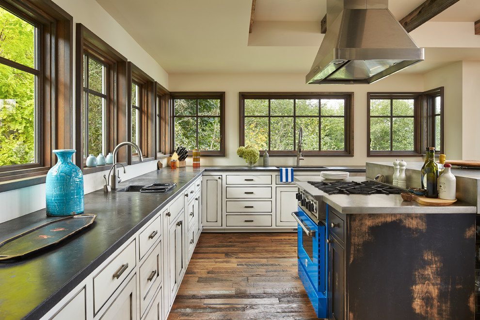 Inspiration for an expansive traditional u-shaped eat-in kitchen in Seattle with a single-bowl sink, recessed-panel cabinets, white cabinets, soapstone benchtops, medium hardwood floors, with island and brown floor.