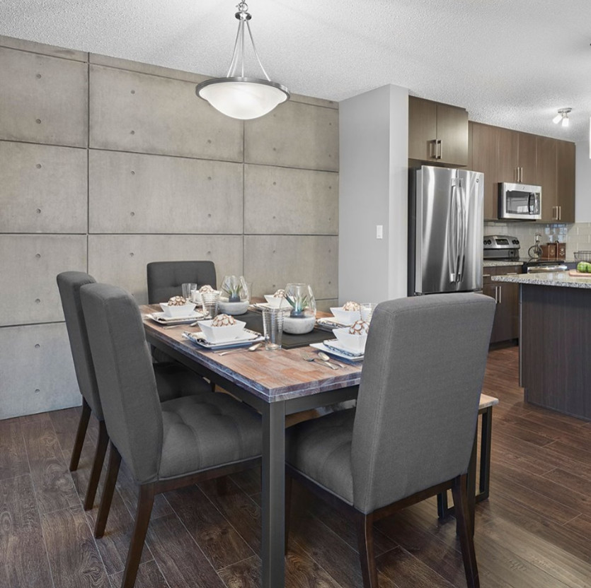 Inspiration for a mid-sized contemporary dark wood floor and brown floor great room remodel in Orange County with an undermount sink, flat-panel cabinets, dark wood cabinets, granite countertops, beige backsplash, porcelain backsplash, stainless steel appliances, an island and gray walls
