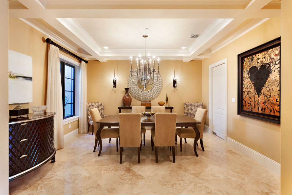 Photo of a large tropical separate dining room in Miami with yellow walls, marble floors, no fireplace and beige floor.