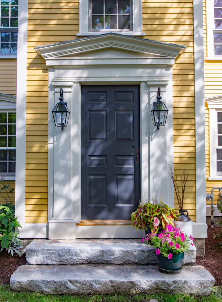 Design ideas for a large country three-storey yellow exterior in Boston with wood siding.