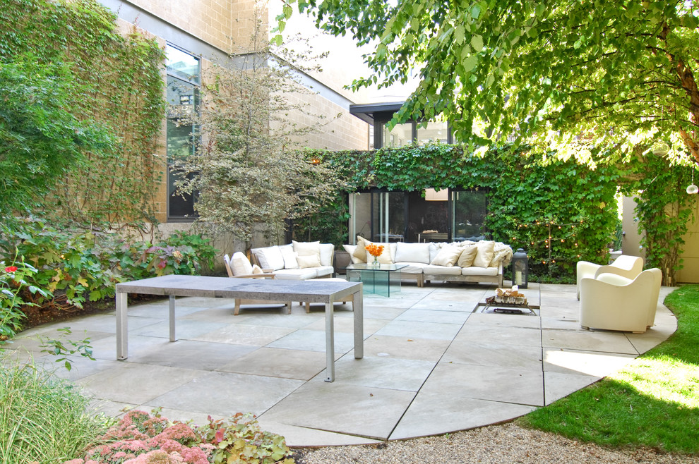 Design ideas for a contemporary patio in Chicago with natural stone pavers.