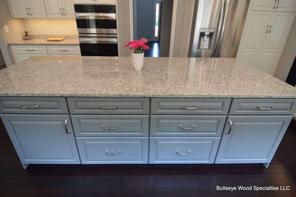 Large transitional u-shaped dark wood floor and brown floor eat-in kitchen photo in DC Metro with an undermount sink, raised-panel cabinets, white cabinets, granite countertops, gray backsplash, glass tile backsplash, stainless steel appliances and an island