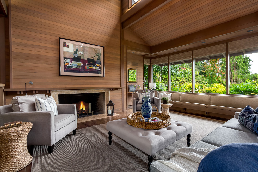 This is an example of an expansive contemporary open concept living room in Seattle with brown walls, medium hardwood floors, a standard fireplace, a stone fireplace surround and brown floor.