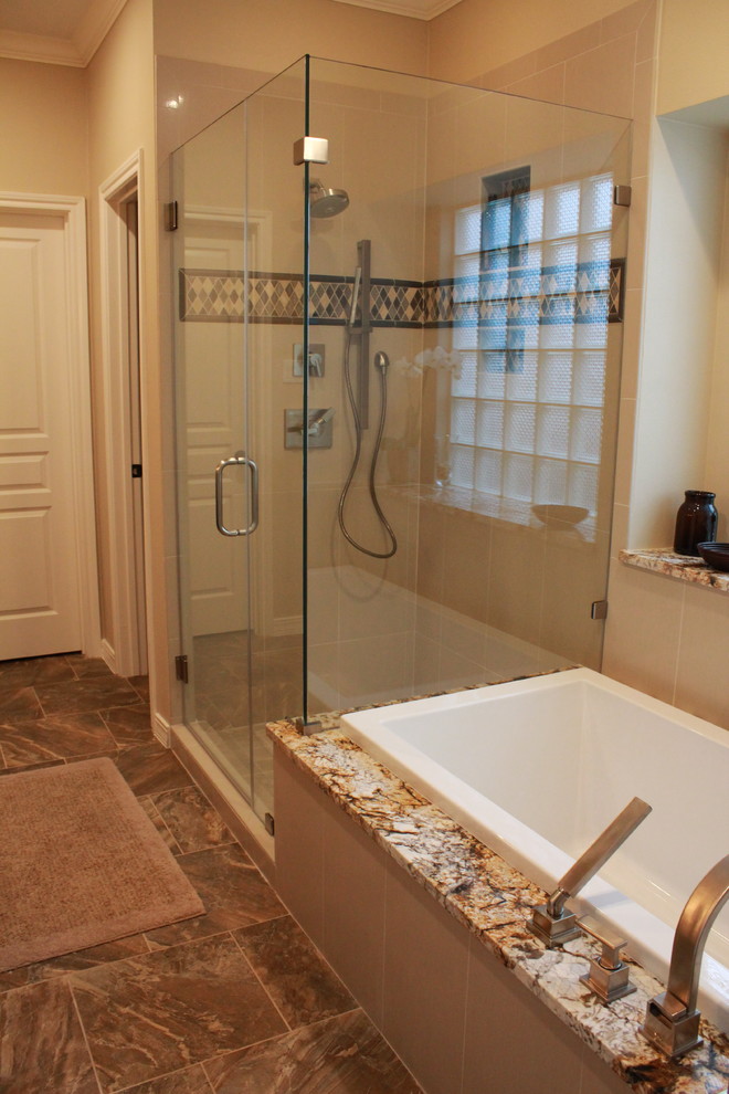 Design ideas for a mid-sized transitional master bathroom in Houston with an undermount sink, shaker cabinets, brown cabinets, granite benchtops, a drop-in tub, a corner shower, a two-piece toilet, beige tile, porcelain tile, beige walls and porcelain floors.