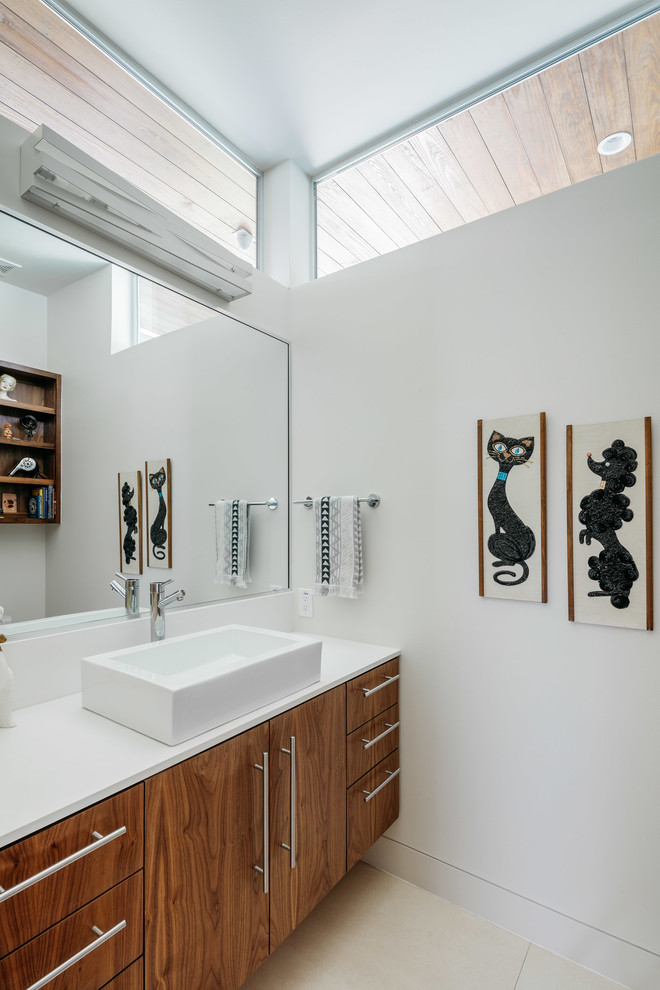 This is an example of a mid-sized midcentury master bathroom in Houston with flat-panel cabinets, medium wood cabinets, an alcove shower, white tile, porcelain tile, white walls, porcelain floors, a vessel sink, engineered quartz benchtops and beige floor.