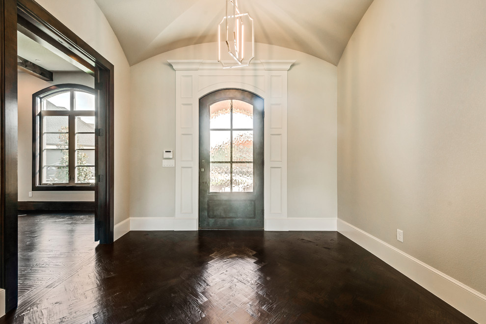 Photo of a mid-sized transitional foyer in Dallas with a single front door and a metal front door.