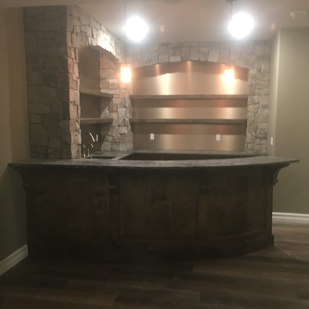Design ideas for a mid-sized country u-shaped wet bar in Calgary with raised-panel cabinets, dark wood cabinets, granite benchtops and vinyl floors.