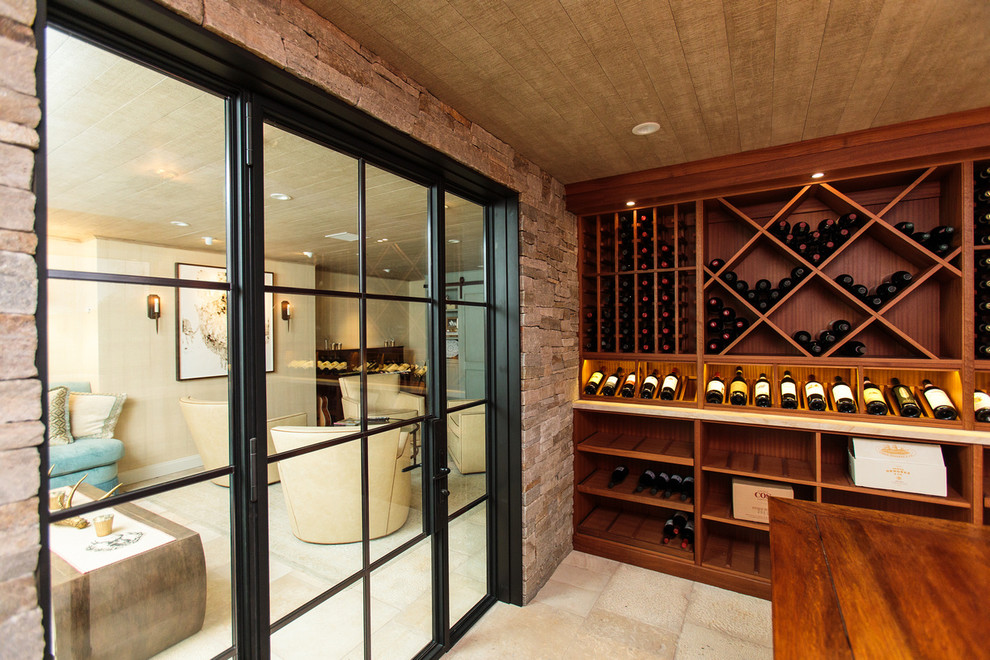 This is an example of a transitional wine cellar in Boston with storage racks.