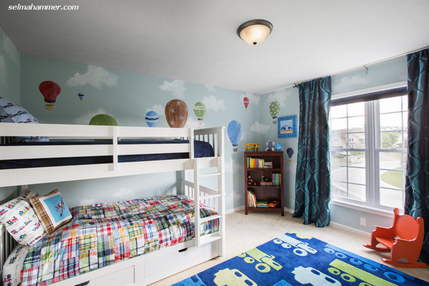 This is an example of a mid-sized eclectic gender-neutral kids' bedroom for kids 4-10 years old in New York with blue walls and carpet.