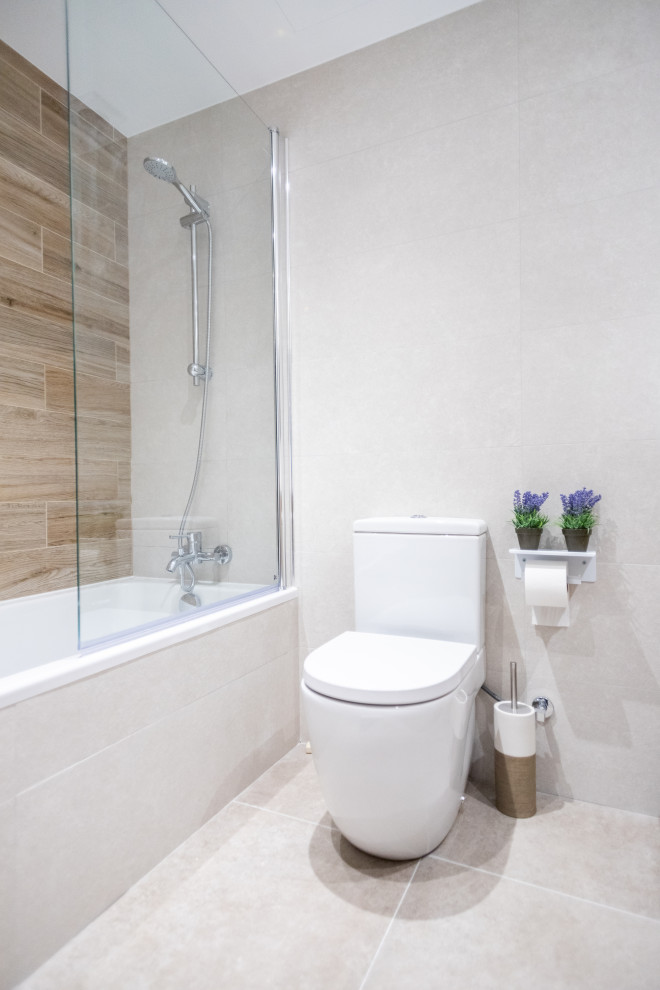 Photo of a medium sized contemporary ensuite bathroom in Barcelona with flat-panel cabinets, medium wood cabinets, an alcove bath, a built-in shower, a one-piece toilet, beige tiles, ceramic tiles, ceramic flooring, a trough sink, tiled worktops, beige floors, a sliding door, white worktops, an enclosed toilet, a single sink and a floating vanity unit.