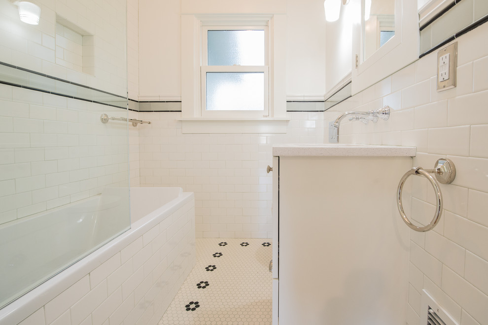 Photo of a small arts and crafts bathroom in Portland with shaker cabinets, white cabinets, a drop-in tub, a shower/bathtub combo, a wall-mount toilet, white tile, subway tile, porcelain floors, an undermount sink, engineered quartz benchtops, white floor and an open shower.