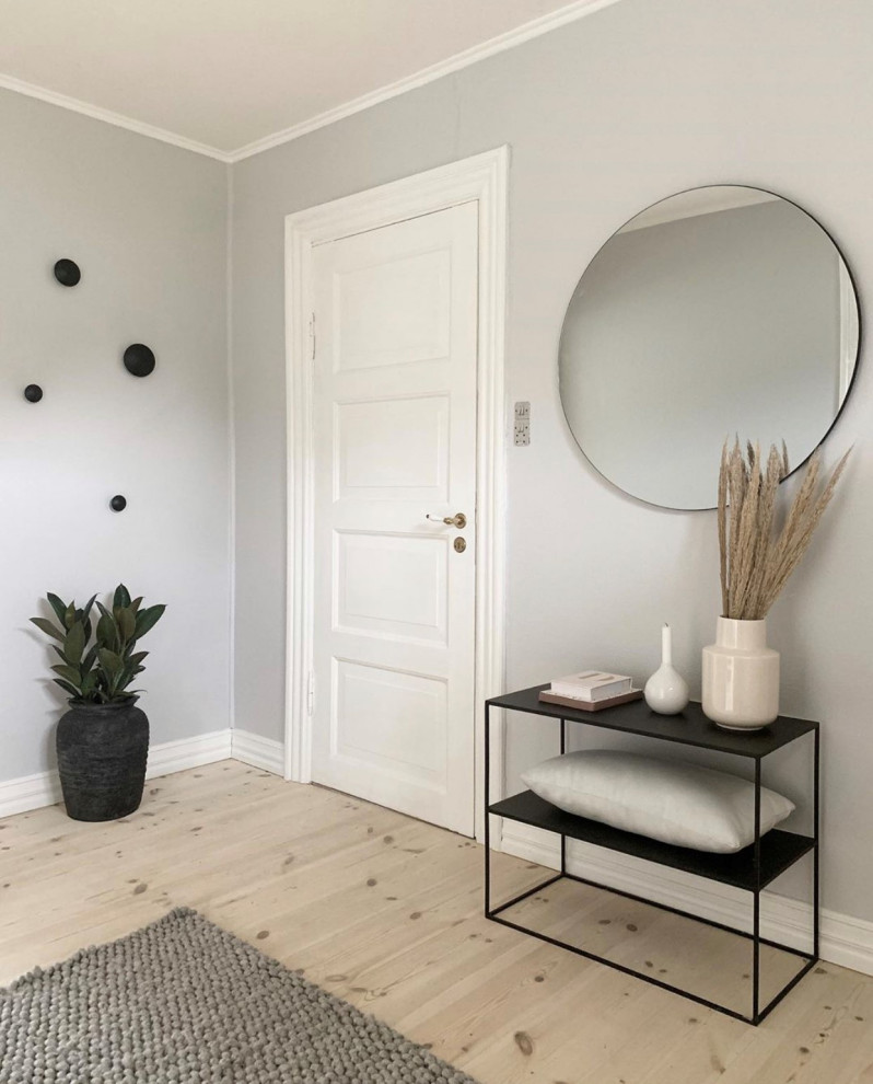 Design ideas for a scandinavian foyer in Aalborg with grey walls, painted wood floors, a double front door, a white front door and white floor.