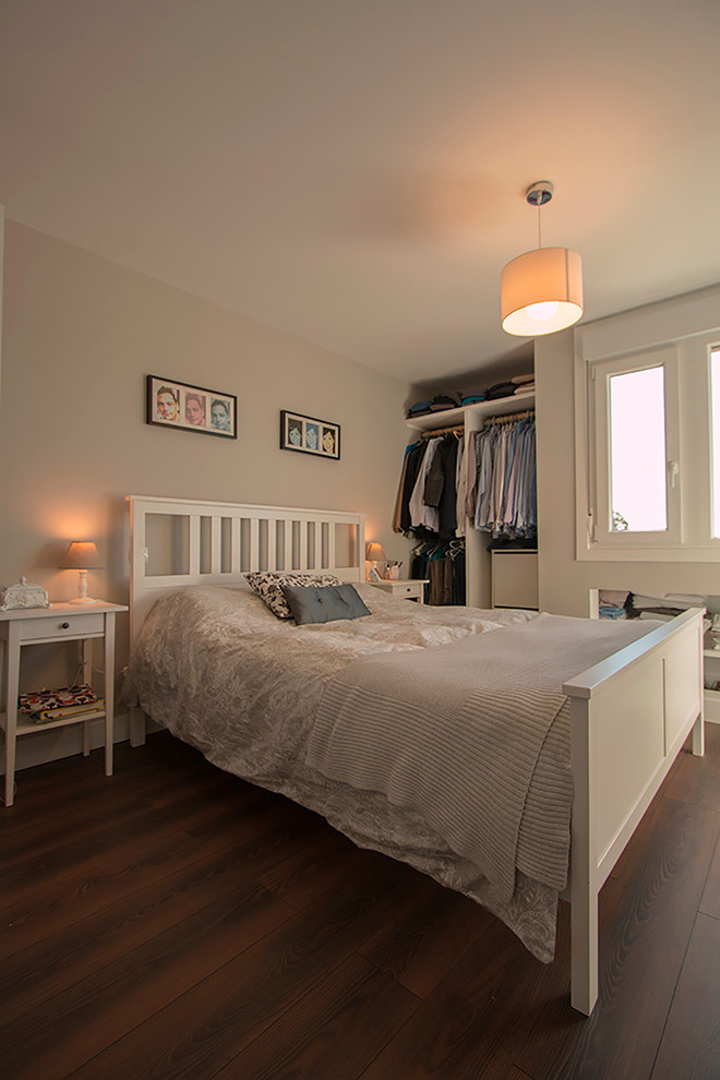 Photo of a mid-sized modern master bedroom in Other with grey walls and dark hardwood floors.