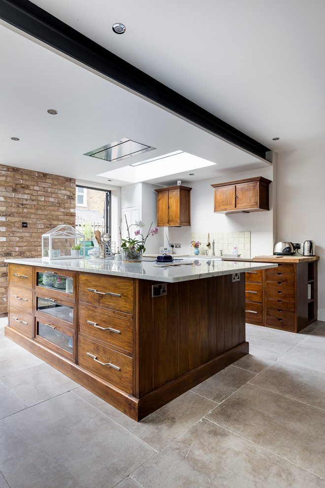 This is an example of an eclectic kitchen in Wiltshire with limestone floors.