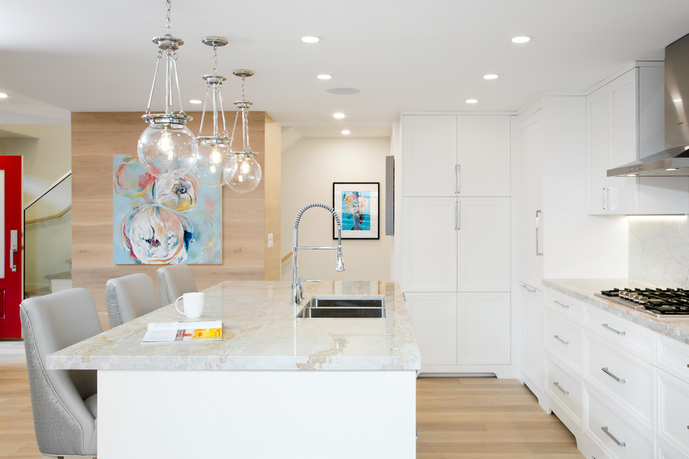 Example of a mid-sized transitional l-shaped light wood floor and beige floor eat-in kitchen design in Vancouver with an undermount sink, raised-panel cabinets, white cabinets, marble countertops, multicolored backsplash, marble backsplash, paneled appliances and an island