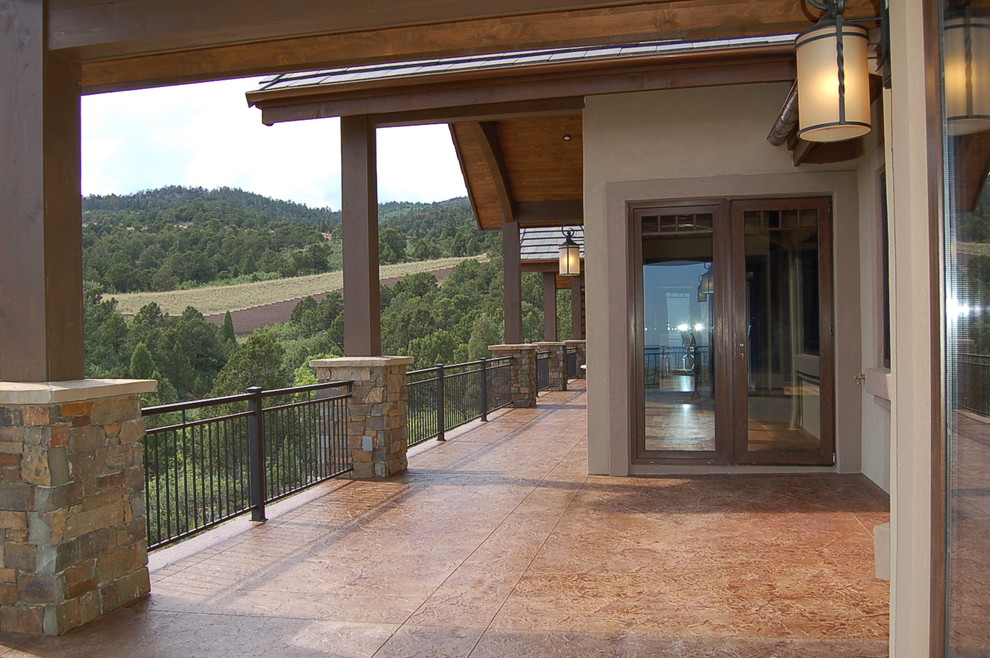 Deck - large rustic side yard deck idea in Denver with a roof extension