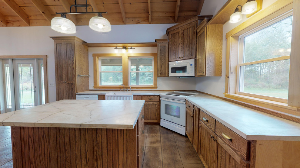 Mid-sized country l-shaped eat-in kitchen in New York with a farmhouse sink, shaker cabinets, medium wood cabinets, concrete benchtops, concrete floors, with island, brown floor and multi-coloured benchtop.