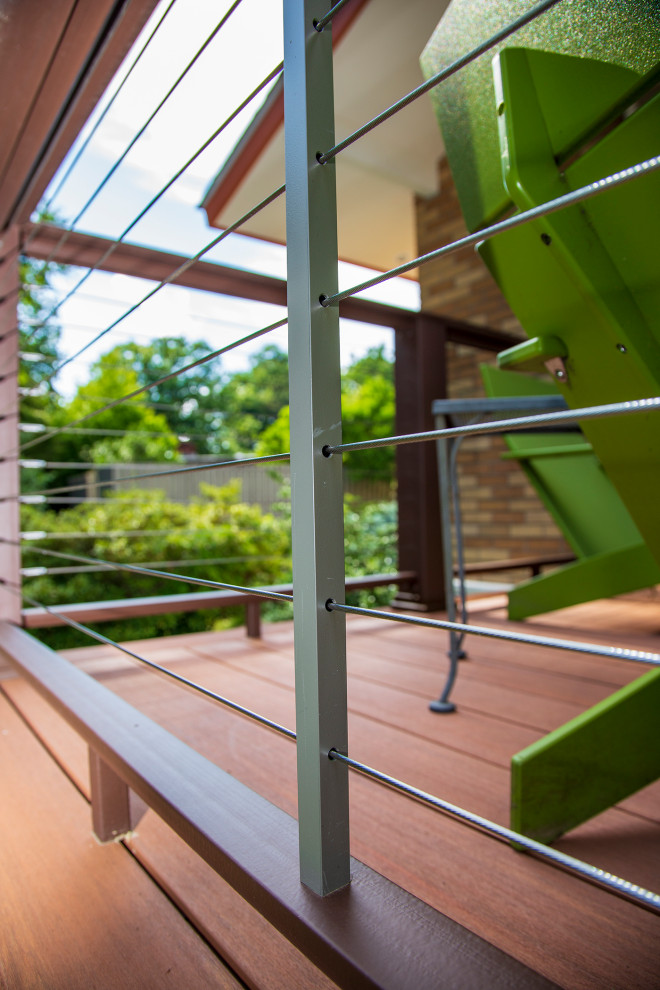 Photo of a medium sized retro back ground level wire cable railing terrace in New York.