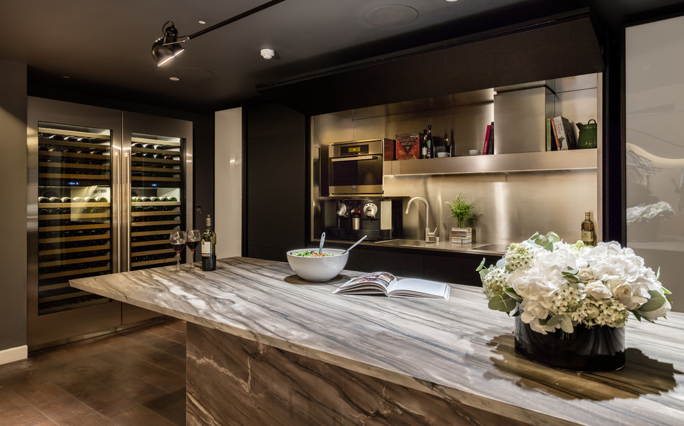 Large minimalist l-shaped brown floor open concept kitchen photo in New York with an undermount sink, flat-panel cabinets, dark wood cabinets, stainless steel appliances, an island and gray countertops