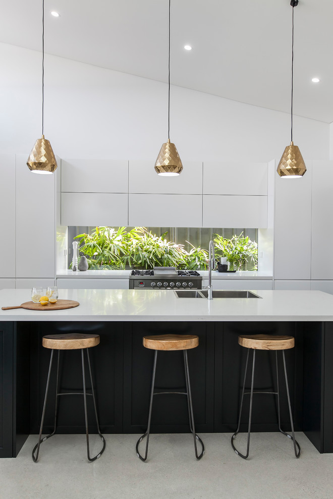 Photo of a mid-sized contemporary kitchen in Wollongong with a drop-in sink, flat-panel cabinets, stainless steel appliances and with island.