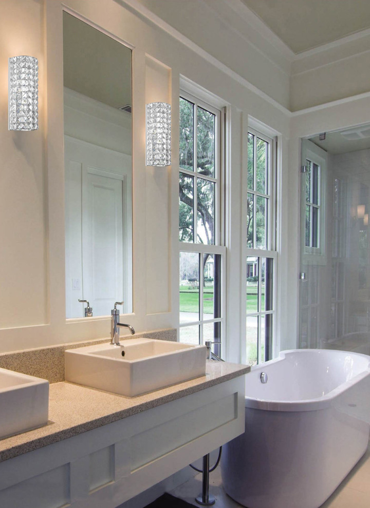 Inspiration for a large contemporary master bathroom in New York with a vessel sink, recessed-panel cabinets, white cabinets, granite benchtops, a freestanding tub, beige tile, ceramic tile, white walls and ceramic floors.