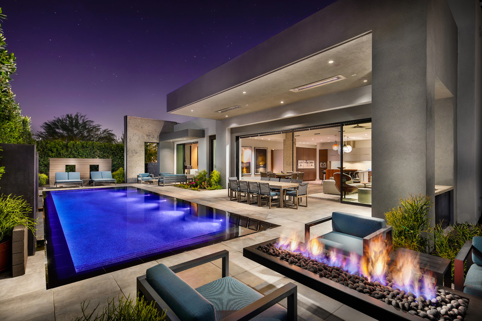 Inspiration for a mid-sized contemporary rectangular pool in Phoenix with tile.