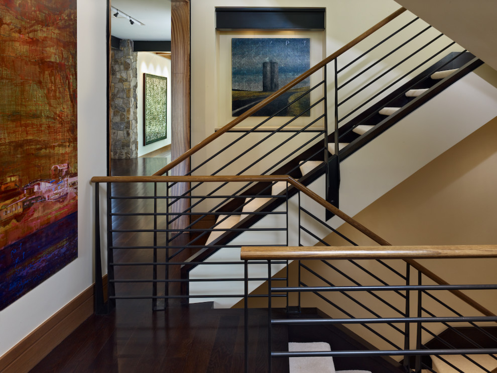 Design ideas for a large contemporary carpeted u-shaped staircase in Denver with open risers and mixed railing.