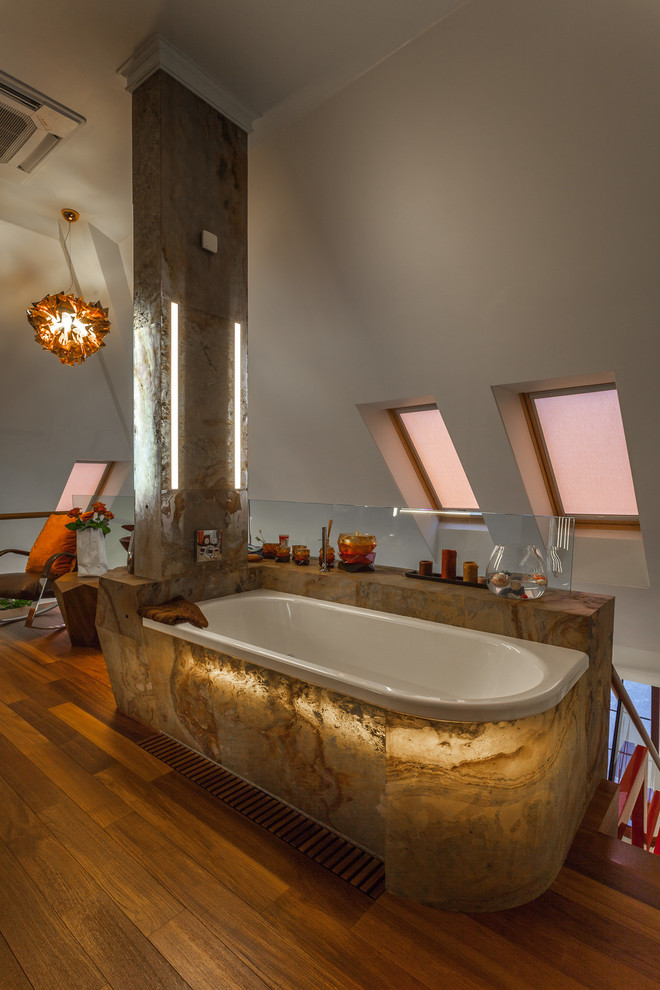 Inspiration for a mid-sized contemporary master bathroom in Moscow with medium hardwood floors, brown floor, beige tile, an open shower, flat-panel cabinets, yellow cabinets, a shower/bathtub combo, slate, white walls, a vessel sink, onyx benchtops and a corner tub.