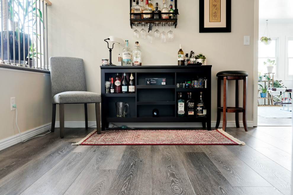 Photo of a mid-sized country single-wall bar cart in Denver with open cabinets, black cabinets, wood benchtops, vinyl floors, brown floor and black benchtop.